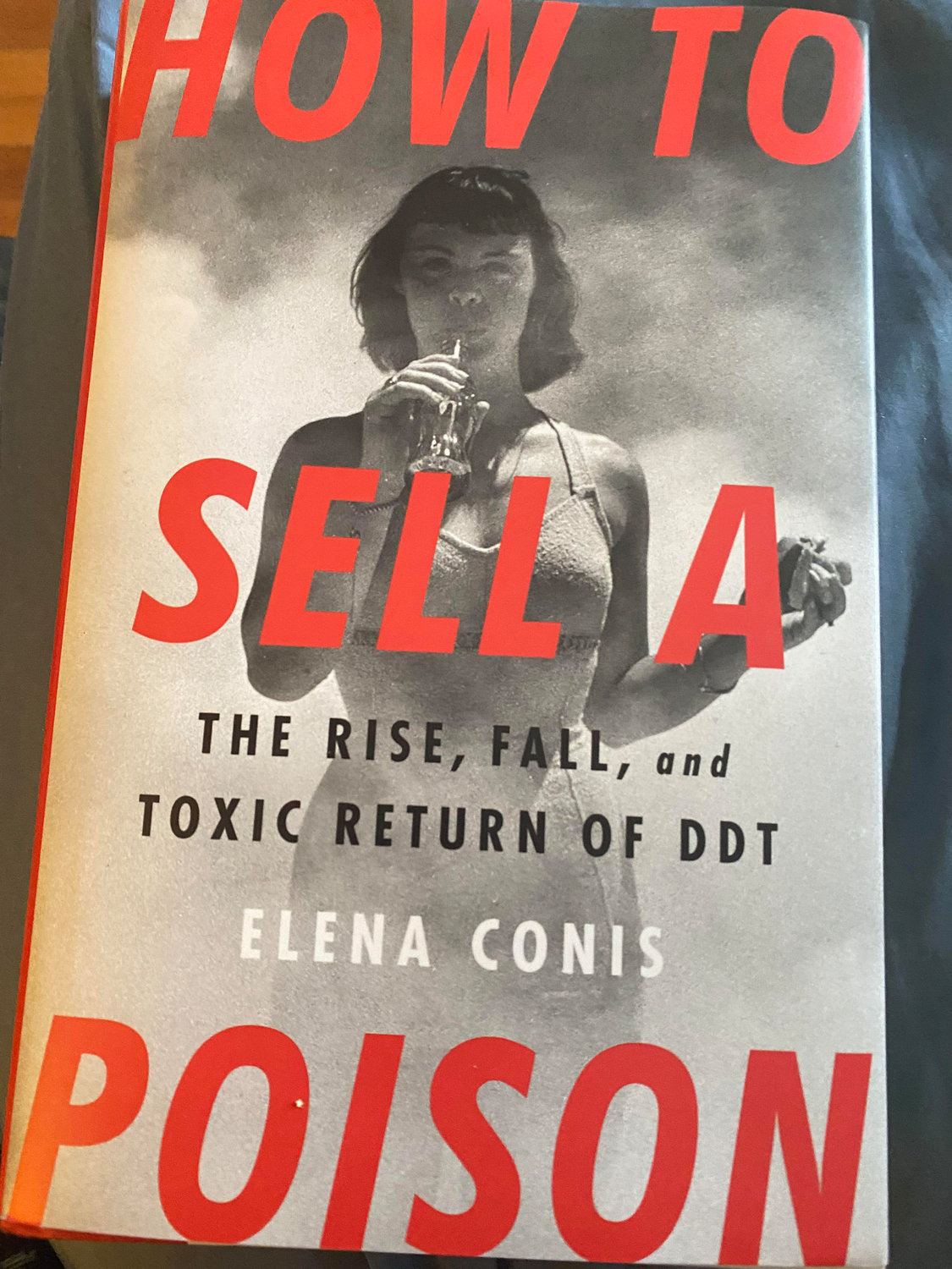 The  cover of Elena Conis's book, How To Sell a Poison, features a model in a bathing suit on Jones Beach in New York drinking a Coke and eating a hamburger, as mists of sprayed DDT swirl about her.